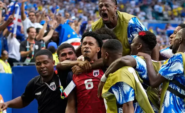 Cape Verde's Kevin Pina, center, celebrates with teammates after scoring the opening goal during the World Cup Group H soccer match between Uruguay and Cape Verde in Miami Gardens, Fla., Sunday, June 21, 2026. (AP Photo/Lynne Sladky)