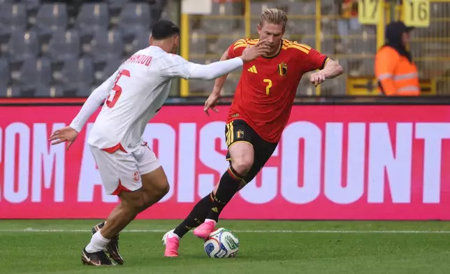 Tunisia's Hadj Mahmoud, left, challenges for the ball with Belgium's Kevin De Bruyne during the international friendly soccer match between Belgium and Tunisia in Brussels, Belgium, Saturday, June 6, 2026. (AP Photo/Omar Havana)