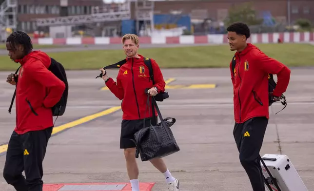 Nathan Ngoy, left, Kevin De Bruyne, center, and Koni De Winter , right, of the national soccer team of Belgium prepare to depart for the 2026 Soccer World Cup at Brussels international airport, in Zaventem, Belgium, Monday, June 8, 2026. (AP Photo/ Omar Havana)