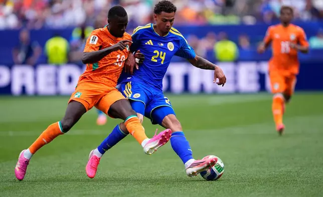 Ivory Coast's Nicolas Pepe (19) and Curaçao's Deveron Fonville (24) fight for the ball during the World Cup Group E soccer match between Curacao and Ivory Coast in Philadelphia, Thursday, June 25, 2026. (AP Photo/Petr David Josek)