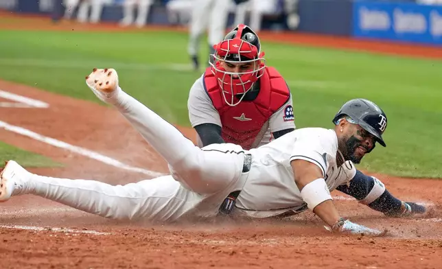 Tampa Bay Rays' Yandy Díaz, front, scores ahead of the tag by Boston Red Sox catcher Mickey Gasper on a sacrifice fly by Ryan Vilade during the fifth inning of a baseball game Wednesday, June 10, 2026, in St. Petersburg, Fla. (AP Photo/Chris O'Meara)