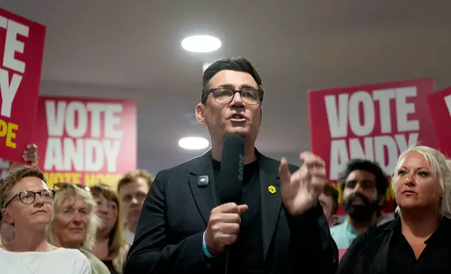 Andy Burnham delivers a speech at St Jude's ARLFC, in Wigan, England, Saturday June 13, 2026, as he campaigns ahead of the Makerfield by-election. (Peter Byrne/PA via AP)