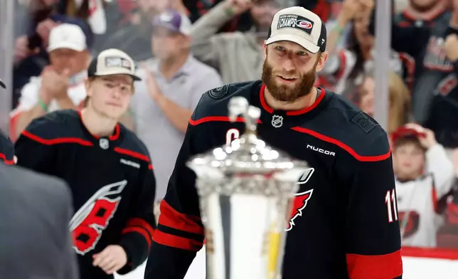 Carolina Hurricanes' Jordan Staal (11) skates to accept the Prince of Wales Trophy following Game 5 of the Eastern Conference finals NHL hockey Stanley Cup playoff series against the Montreal Canadiens in Raleigh, N.C., Friday, May 29, 2026. (AP Photo/Karl DeBlaker)