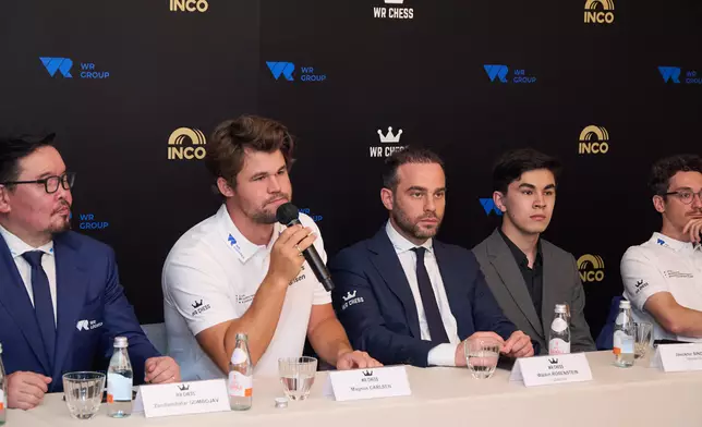 Magnus Carlsen (Left 2), five-time World Champion, answers questions from reporters at the WR Chess press conference in Hong Kong, 16 June 2026.