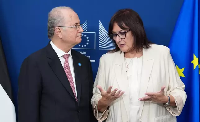 European Commissioner for the Mediterranean Dubravka Suica, right, speaks with Palestinian Prime Minister Mohammad Mustafa after participating in a signature ceremony during a Palestinian Donors Group meeting at EU headquarters in Brussels, Monday, July 13, 2026. (AP Photo/Marius Burgelman)