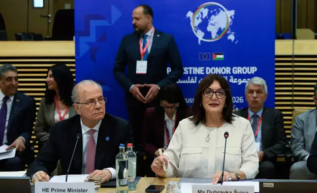 European Commissioner for the Mediterranean Dubravka Suica, right, and Palestinian Prime Minister Mohammad Mustafa participate in a round table meeting of the Palestinian Donor Group at EU headquarters in Brussels, Monday, July 13, 2026. (John Thys, Pool Photo via AP)