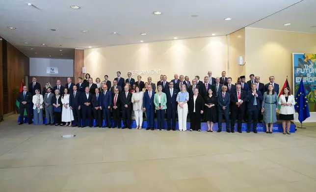 European Commissioner for the Mediterranean Dubravka Suica, front center right, and Palestinian Prime Minister Mohammad Mustafa, front center left, pose for a group photo with other officials at a Palestinian Donors Group meeting at EU headquarters in Brussels, Monday, July 13, 2026. (AP Photo/Marius Burgelman)
