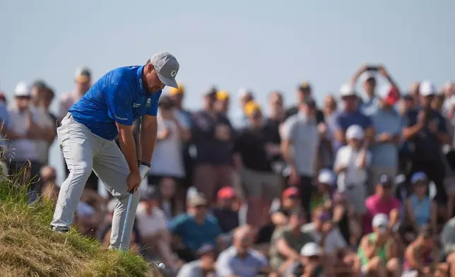 Bryson DeChambeau of the United States plays from an awkward lie to the 5th green during the second day of the British Open Golf championships at Royal Birkdale golf club, in Southport, England, Friday, July 17, 2026. (AP Photo/David Goldman)