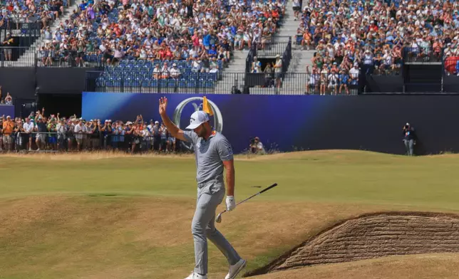 Sam Burns of the United States acknowledges the crowd after holding out from a bunker on the 18th green during the second day of the British Open Golf championships at Royal Birkdale golf club, in Southport, England, Friday, July 17, 2026. (AP Photo/Peter Morrison)