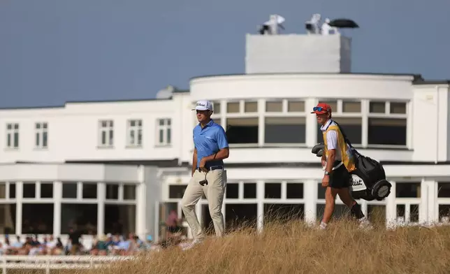 Jackson Suber of the United States, and his caddie Greyson Porter walks towards the 18th green during the first day of the British Open Golf championships at Royal Birkdale golf club, in Southport, England, Thursday, July 16, 2026. (AP Photo/Peter Morrison)