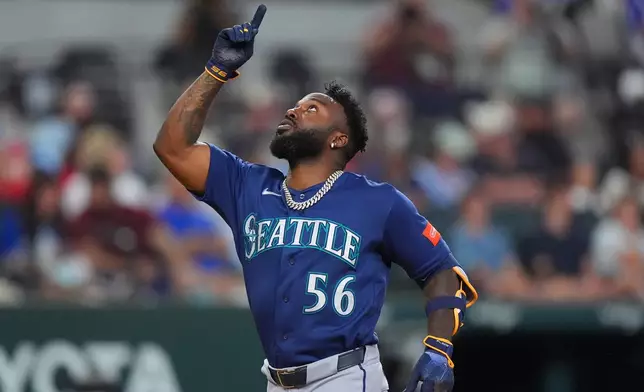 Seattle Mariners' Randy Arozarena celebrates his home run during the seventh inning of a baseball game against the Texas Rangers, Sunday, July 26, 2026, in Arlington, Texas. (AP Photo/LM Otero)