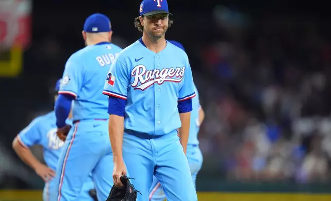 Texas Rangers starting pitcher Jacob Degrom heads to the dugout after being pulled from the mound during the sixth inning of a baseball game against the against the Seattle Mariners, Sunday, July 26, 2026, in Arlington, Texas. (AP Photo/LM Otero)