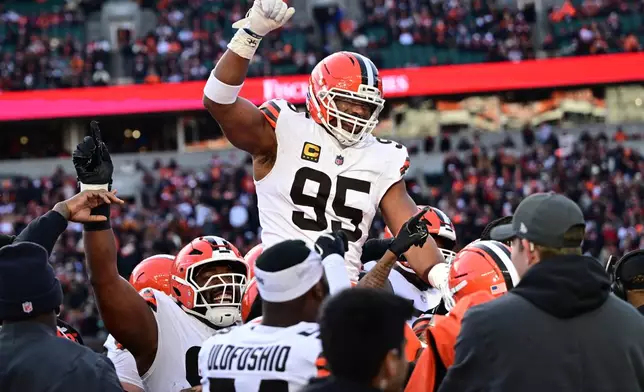 FILE - Cleveland Browns defensive end Myles Garrett, center, celebrates with teammates after breaking the NFL single season sack record during the second half of an NFL football game against the Cincinnati Bengals in Cincinnati, Jan. 4, 2026. (AP Photo/David Dermer, File)