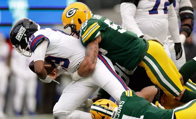 FILE - Green Bay Packers' Micah Parsons and Isaiah McDuffie sack New York Giants' Jameis Winston during the second half of an NFL football game, Nov. 16, 2025, in East Rutherford, N.J. (AP Photo/Adam Hunger, File)