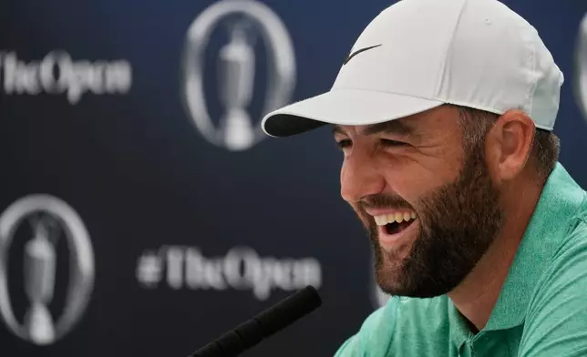 Scottie Scheffler of the United States laughs during a press conference ahead of the British Open Golf championships at Royal Birkdale golf club, in Southport, England, Tuesday, July 14, 2026. (AP Photo/David Goldman)