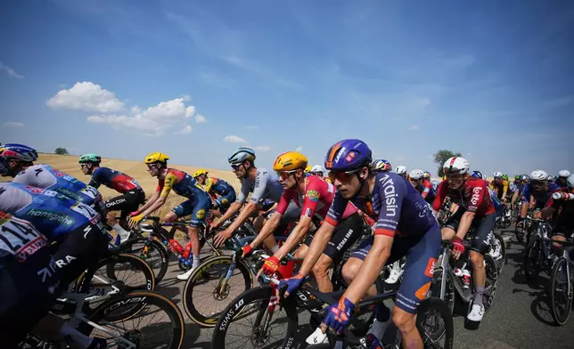The pack rides during the eleventh stage of the Tour de France cycling race with start in Vichy and finish in Nevers, France, Wednesday, July 15, 2026. (AP Photo/Mosa'ab Elshamy)