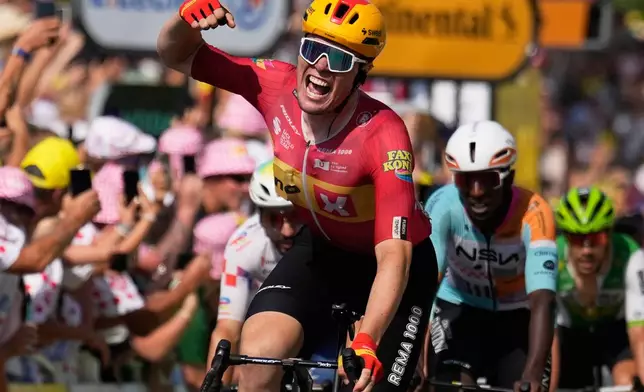 Norway's Soren Waerenskjold celebrates as he crosses the finish line to win the eleventh stage of the Tour de France cycling race with start in Vichy and finish in Nevers, France, Wednesday, July 15, 2026. (AP Photo/Mosa'ab Elshamy)