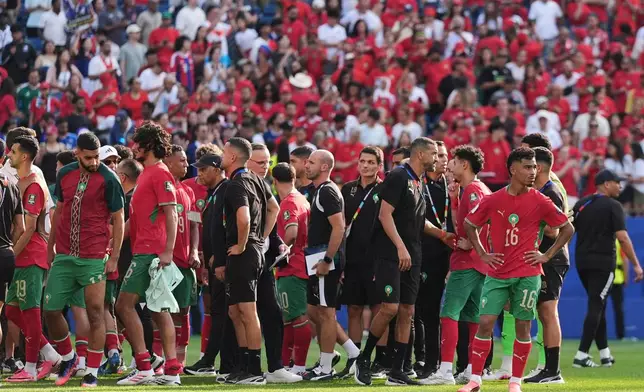 Morocco team and staff walk off the pitch after the World Cup quarterfinal soccer match between France and Morocco in Foxborough, Mass., near Boston, Thursday, July 9, 2026. (AP Photo/Stephanie Scarbrough)
