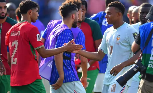 Morocco's Achraf Hakimi (2) and France's Kylian Mbappe (10) greet each other after the World Cup quarterfinal soccer match between France and Morocco in Foxborough, Mass., near Boston, Thursday, July 9, 2026. (AP Photo/Steven Senne)