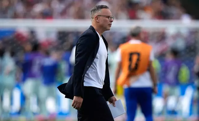 Morocco head coach Mohamed Ouahbi walks across the pitch at the end of the World Cup quarterfinal soccer match between France and Morocco in Foxborough, Mass., near Boston, Thursday, July 9, 2026. (AP Photo/Matt Slocum)