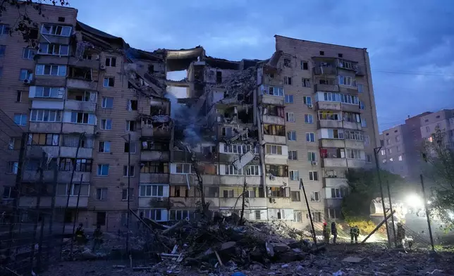 Rescuers work the scene of a building damaged by Russian missile attack in Kyiv, Ukraine, Monday, July 6, 2026. (AP Photo/Efrem Lukatsky)