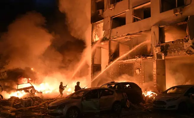 Emergency services personnel work to extinguish a fire following Russian missile attacks in Kyiv, Ukraine, Monday, July 6, 2026. (AP Photo/Danylo Antoniuk)