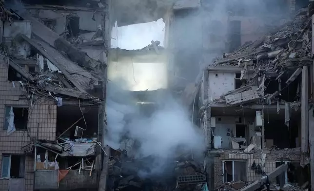 The damaged apartment interior in the ruined building following Russian missile attack in Kyiv, Ukraine, Monday, July 6, 2026. (AP Photo/Efrem Lukatsky)