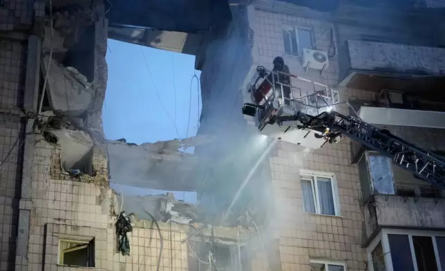 Rescuers work the scene of a building damaged by Russian missile attack in Kyiv, Ukraine, Monday, July 6, 2026. (AP Photo/Efrem Lukatsky)