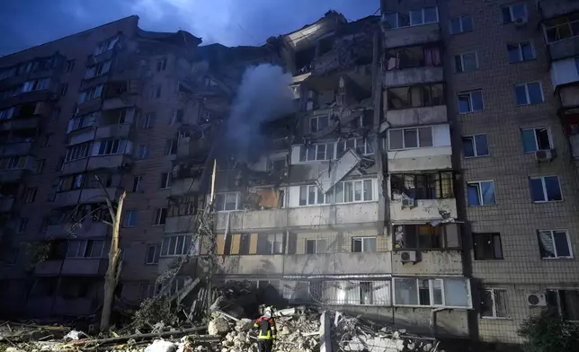 Rescuers work the scene of a building damaged by Russian missile attack in Kyiv, Ukraine, Monday, July 6, 2026. (AP Photo/Efrem Lukatsky)