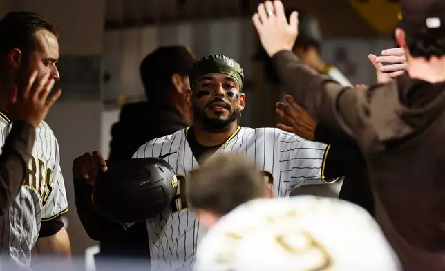 San Diego Padres' Luis Campusano is congratulate by teammates after scoring on a double hit by Miguel Andujar against the Arizona Diamondbacks in the fourth inning of a baseball game Wednesday, July 8, 2026, in San Diego. (AP Photo/Derrick Tuskan)