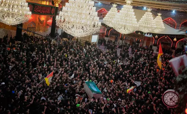 The coffin of the late Iranian Supreme Leader Ayatollah Ali Khamenei is carried through a crowd of mourners at the Imam Hussein Shrine in Karbala, Iraq, early Thursday, July 9, 2026. (AP Photo/Khalil Hamra)