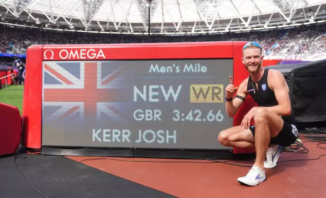 Britain's Josh Kerr celebrates after winning and breaking a world record in the Men's 1 Mile final during the Novuna London Athletics Meet at the London Stadium, Saturday July 18, 2026. (Adam Davy/PA via AP)