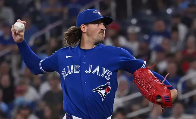 Toronto Blue Jays pitcher Kevin Gausman throws to a Tampa Bay Rays batter during during the first inning of a baseball game in Toronto on Tuesday, July 21, 2026. (Jon Blacker/The Canadian Press via AP)