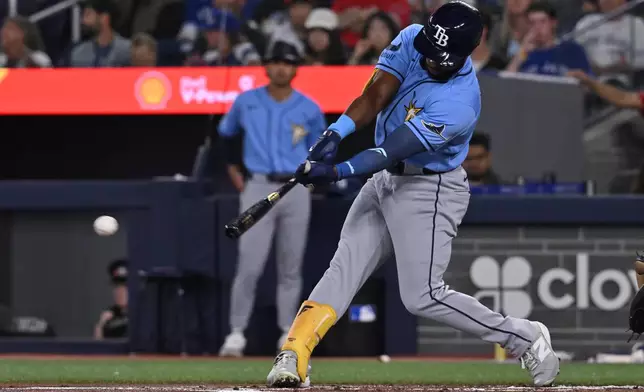 Tampa Bay Rays' Cedric Mullins (31) hits a double against the Toronto Blue Jays during the first inning of a baseball game in Toronto on Tuesday, July 21, 2026. (Jon Blacker/The Canadian Press via AP)