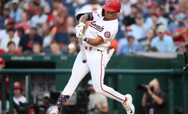 Washington Nationals' Daylen Lile hits a double driving in a run during the third inning of a baseball game against the Houston Astros, Wednesday, July 8, 2026, in Washington. (AP Photo/Nick Wass)