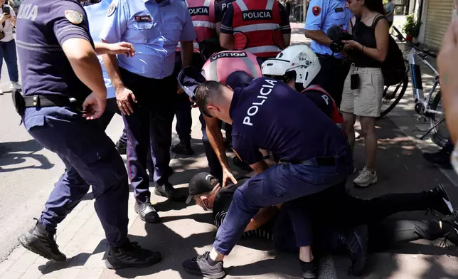 Police detain a protester during clashes at an anti-government rally in Tirana, Albania, Thursday, July 2, 2026. (AP Photo/Hameraldi Agolli)