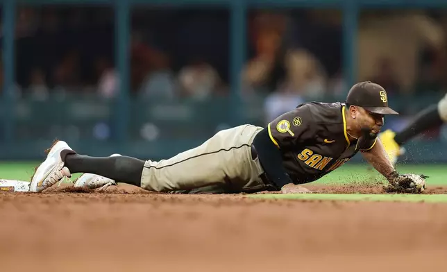 San Diego Padres shortstop Xander Bogaerts tags second base in the third inning of a baseball game against the Atlanta Braves, Wednesday, July 22, 2026, in Atlanta. (AP Photo/Colin Hubbard)