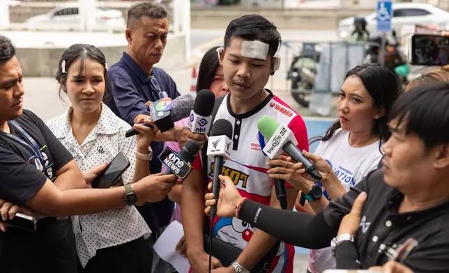 Natthaphong Lakhorn, a 26-year-old survivor of the Rong Beer Na Ladprao bar fire, speaks to journalists outside the Phahonyothin Police Station in Bangkok, Thailand, Wednesday, July 15, 2026. (AP Photo/Anton L. Delgado)