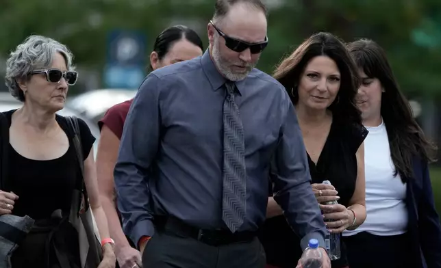 Matt Robinson, father, and Amber Robinson, mother, second right, of Tyler Robinson arrive at the Fourth District Courthouse, Tuesday, July 7, 2026, in Provo, Utah, ahead of a hearing for Tyler Robinson, accused in the fatal shooting of Charlie Kirk. (AP Photo/Spenser Heaps)