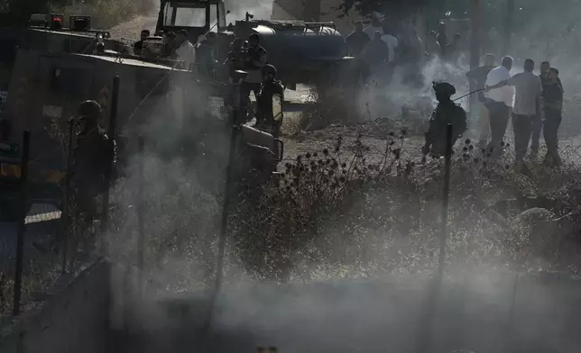 Members of the Israeli forces are seen on a street following an attack by Israeli settlers in the village of Sarra, near the West Bank city of Nablus, Friday, July 24, 2026. (AP Photo/Majdi Mohammed)