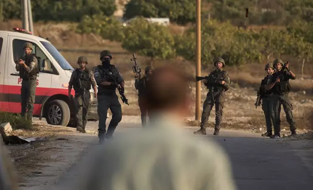 Members of Israeli forces stand guard during a raid in the village of Sarra, near the West Bank city of Nablus, Saturday, July 25, 2026. (AP Photo/Leo Correa)