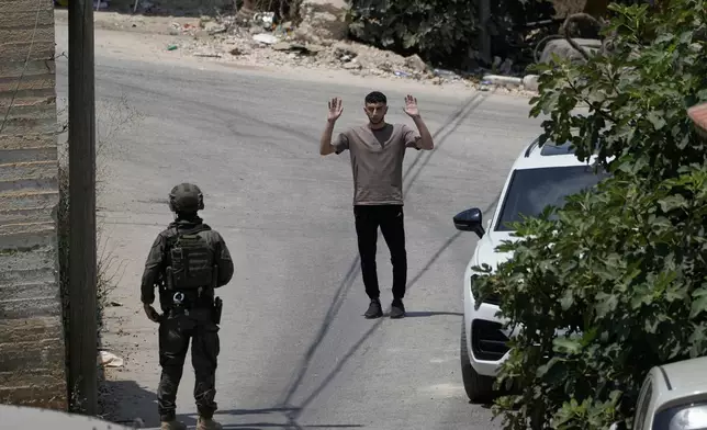 An Israeli soldier interrogates a Palestinian resident during an army operation in the West Bank village of Tell, near Nablus, Saturday July 25, 2026. (AP Photo/Majdi Mohammed)