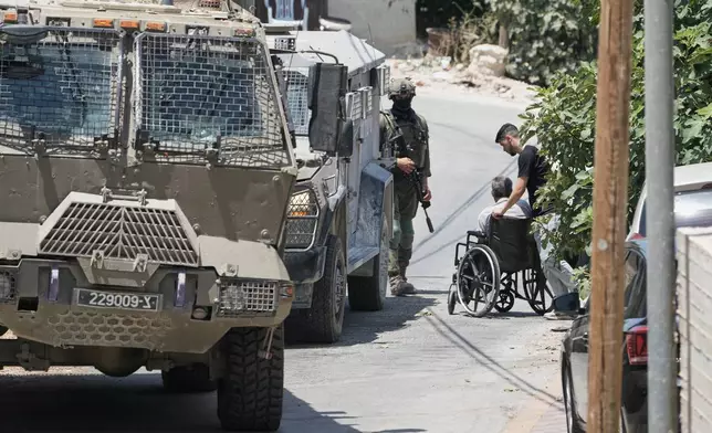 Israeli soldiers interrogate Palestinian residents during an army operation in the West Bank village of Tell, near Nablus, Saturday July 25, 2026. (AP Photo/Majdi Mohammed)