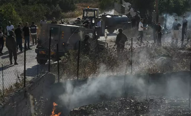 Members of the Israeli forces are seen on a street following an attack by Israeli settlers in the village of Sarra, near the West Bank city of Nablus, Friday, July 24, 2026. (AP Photo/Majdi Mohammed)