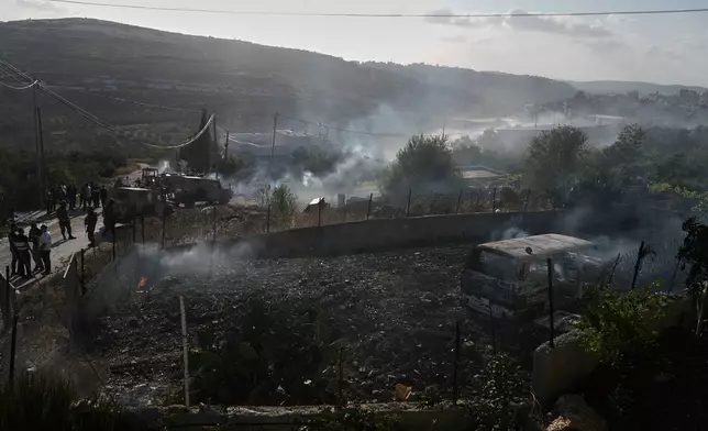 Members of the Israeli forces are seen on a street following an attack by Israeli settlers in the village of Sarra, near the West Bank city of Nablus, Friday, July 24, 2026. (AP Photo/Majdi Mohammed)