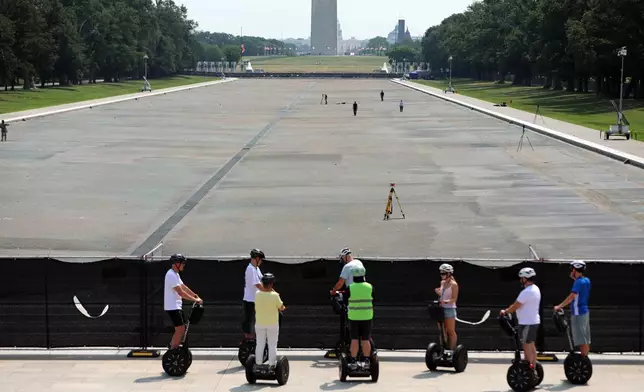 The Reflecting Pool, Washington Monument and U.S. Capitol are seen, Wednesday, July 15, 2026, in Washington. (AP Photo/Rahmat Gul)