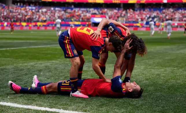 Spain's Mikel Oyarzabal (21) celebrates scoring his side's third goal against Austria with teammates Gavi (9) and Marc Cucurella during the World Cup round of 32 soccer match in Inglewood, Calif., near Los Angeles, Thursday, July 2, 2026. (AP Photo/Mark J. Terrill)