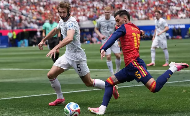 Spain's Alex Baena, right, kicks the ball against Austria's Stefan Posch (5) during the World Cup round of 32 soccer match between Spain and Austria in Inglewood, Calif., near Los Angeles, Thursday, July 2, 2026. (AP Photo/Jae C. Hong)