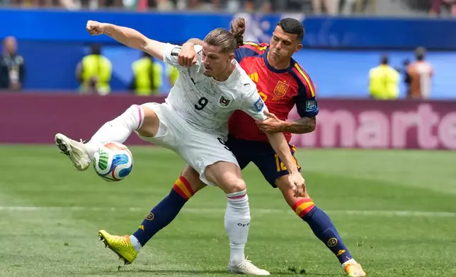 Austria's Marcel Sabitzer (9) and Spain's Pedro Porro battle for the ball during a World Cup round of 32 soccer match in Inglewood, Calif., near Los Angeles, Thursday, July 2, 2026. (AP Photo/Andre Penner)