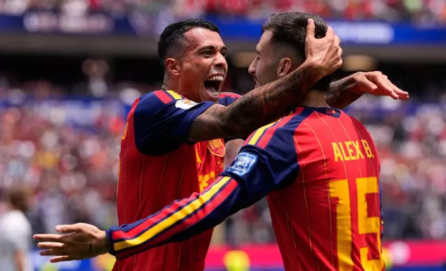 Spain's Pedro Porro, left, celebrates scoring his side's second goal against Austria with teammates Alex Baena during the World Cup round of 32 soccer match in Inglewood, Calif., near Los Angeles, Thursday, July 2, 2026. (AP Photo/Mark J. Terrill)